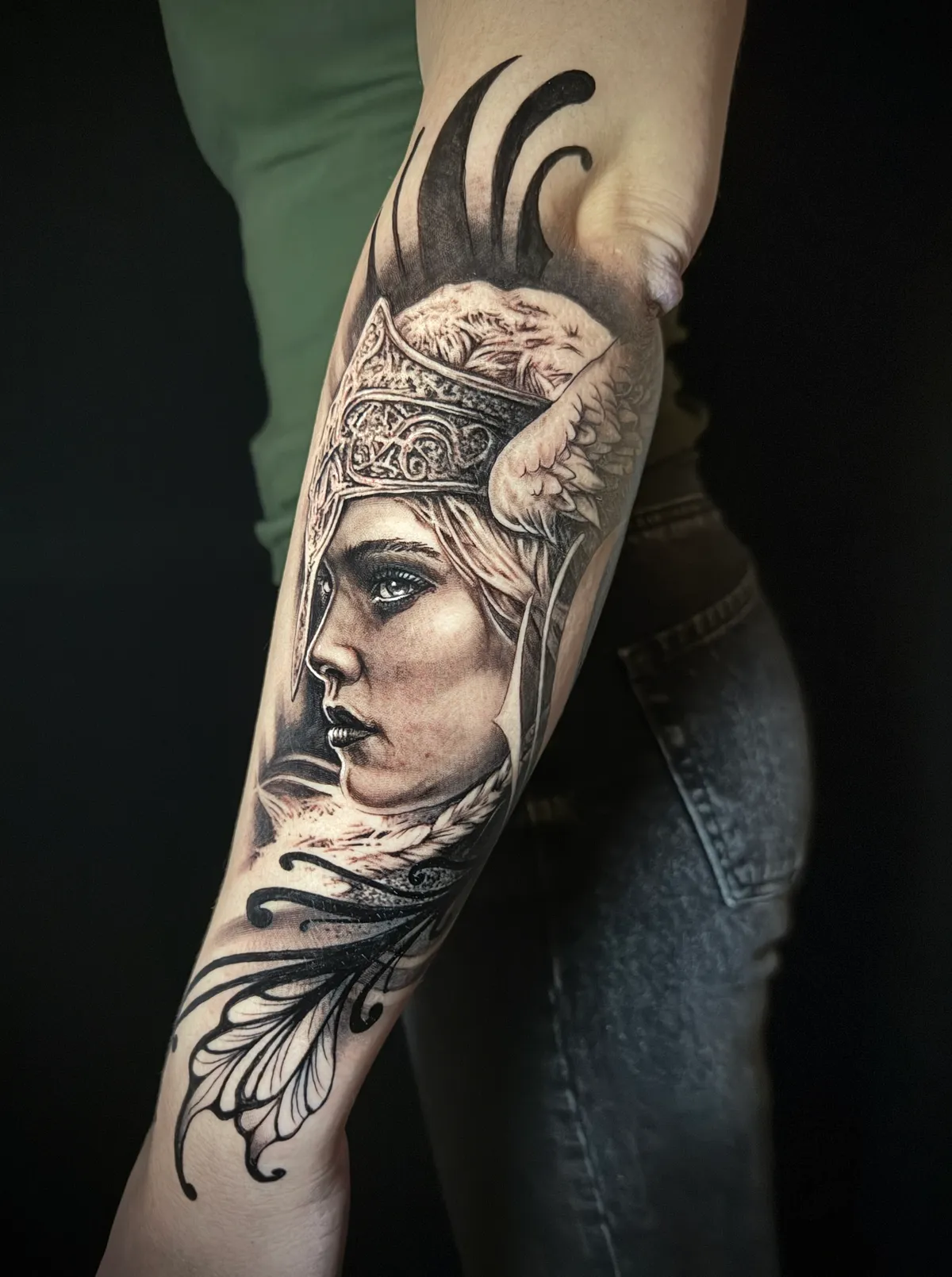 Black and grey realism Valkyrie warrior woman portrait with winged helmet forearm tattoo by Paul Michael Andras
