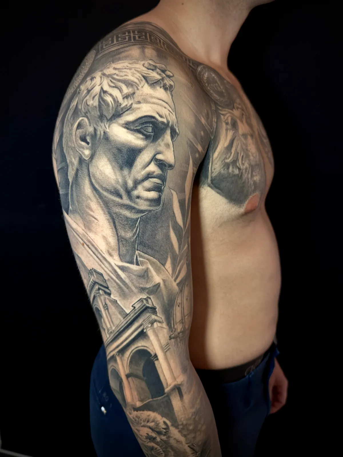 Black and grey realism Roman statue portrait with classical architecture full sleeve tattoo by Andras Tattoo