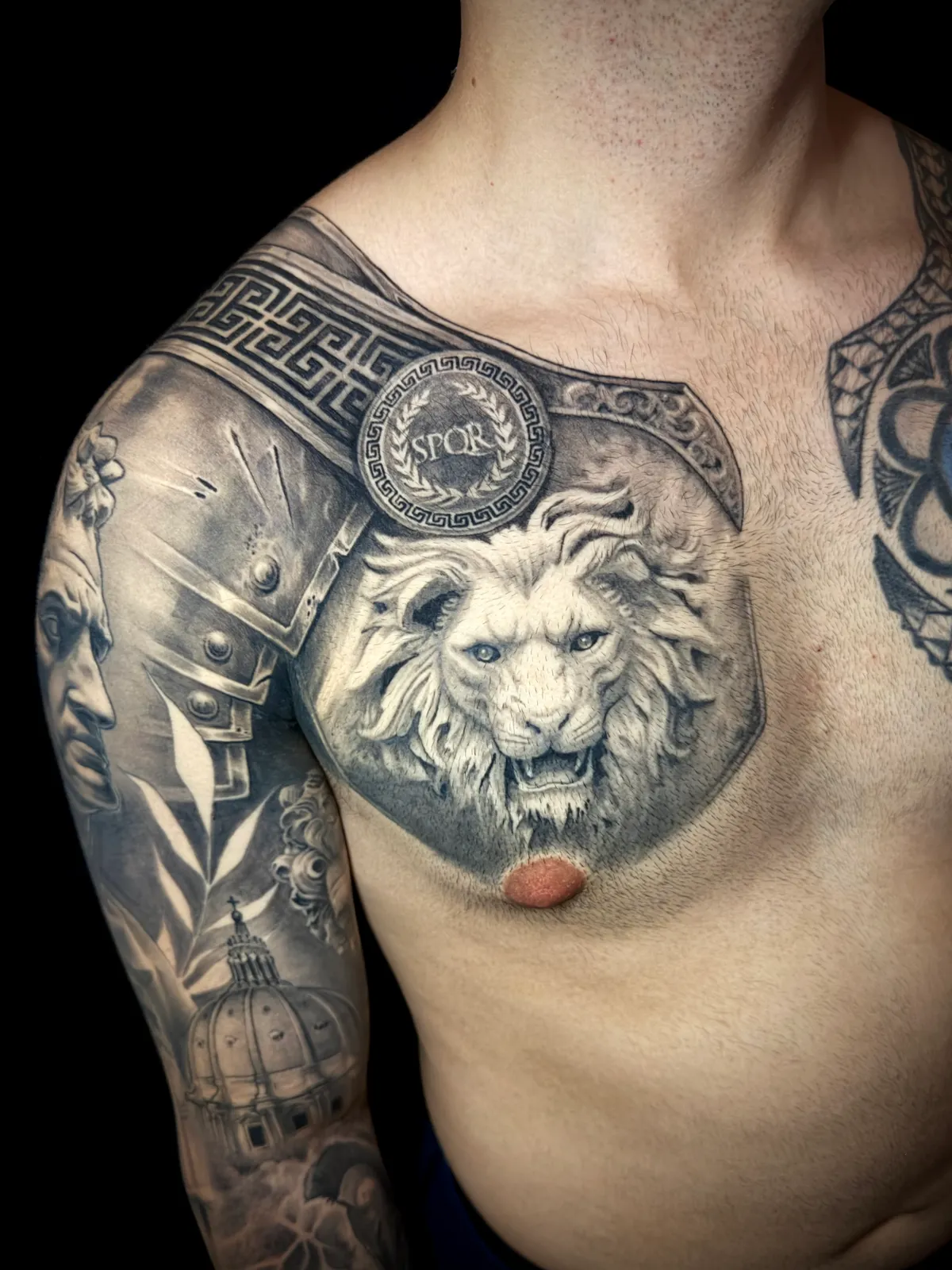 Black and grey realism Roman SPQR chest plate armor with lion head and Greek key pattern chest tattoo by Andras Tattoo