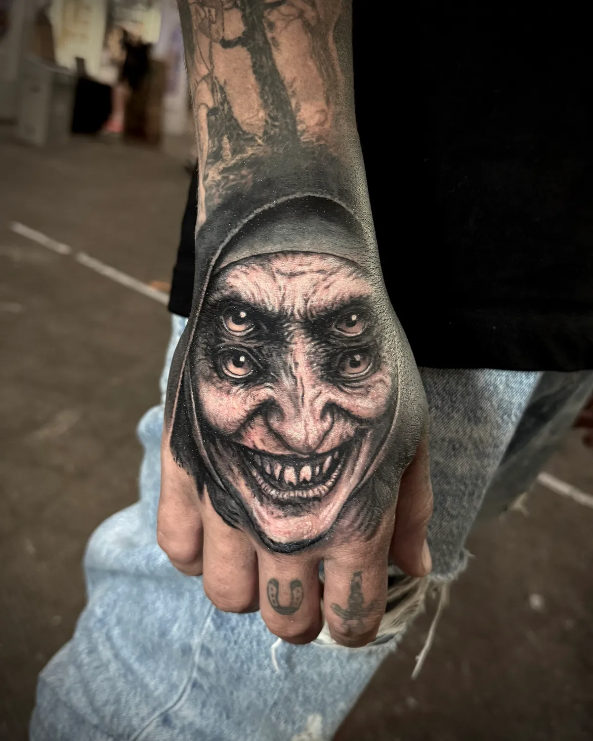 Black and grey realism horror nun from The Conjuring hand tattoo by Andras Tattoo
