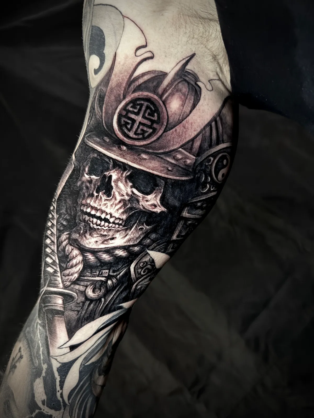 Black and grey realism Japanese samurai skull with helmet and sword forearm sleeve tattoo by Paul Michael Andras