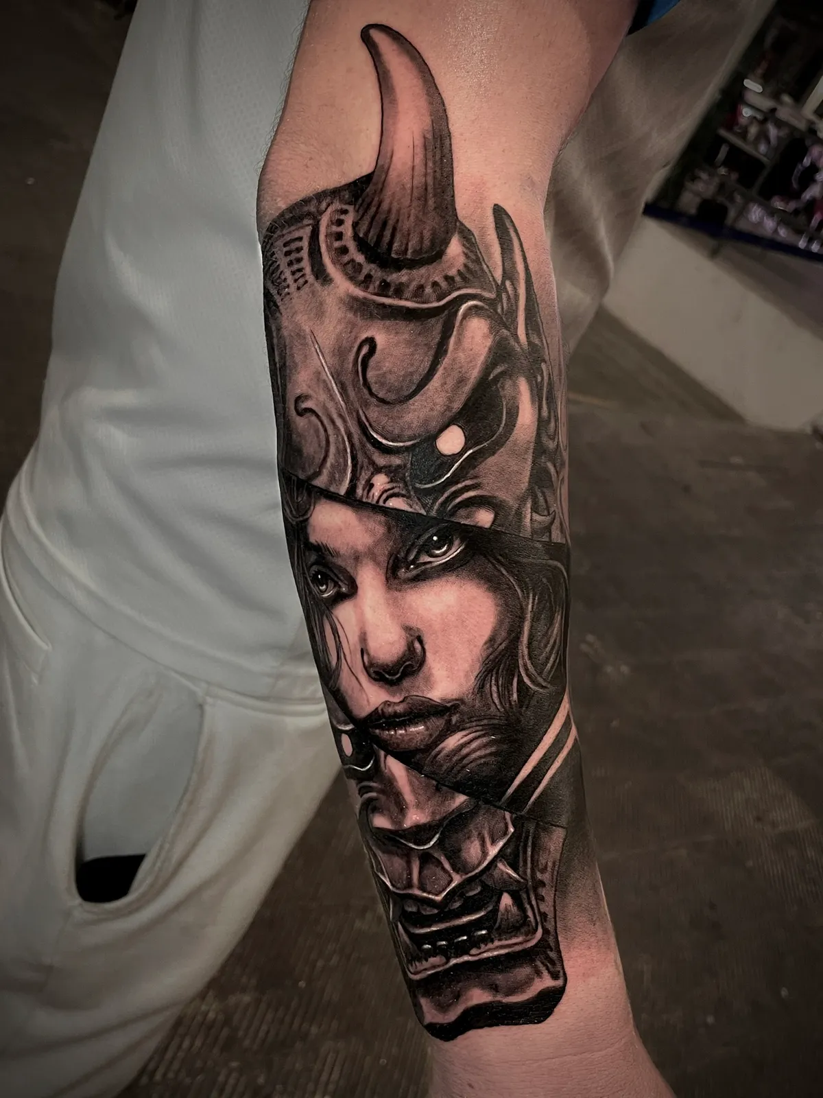 Black and grey realism female samurai warrior with horned helmet forearm tattoo by Andras Tattoo